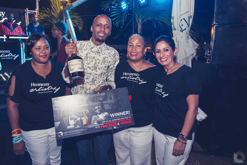 Cciza Williams, Winner of the all expense trip to Nigeria for the Hennessy Artistry Finale acceps his prize from Director of QWAY International Niloofer Hirjee and her team